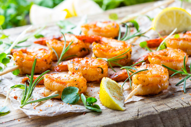 Grilled fried Shrimps Prawns on wooden skewers with spices