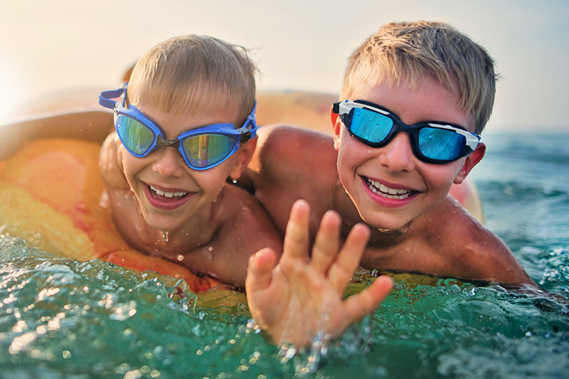 Kids wearing goggles playing in the pool