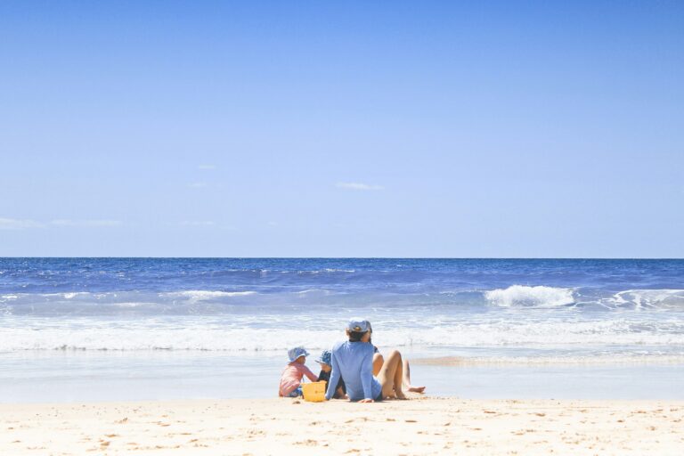 Family with a young child on the beach.