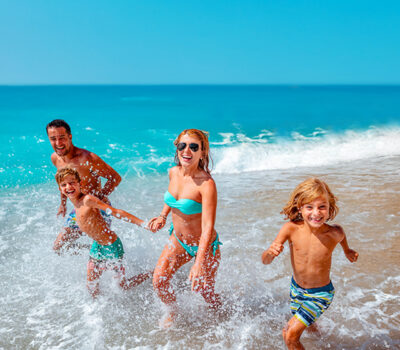 Young family play on beach